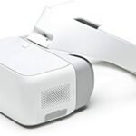 White VR headset with an adjustable head strap, featuring a sleek design and branding on the side.