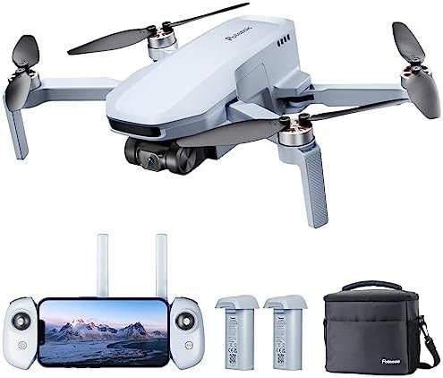 A white drone with propellers, remote control displaying a mountain image, two batteries, and a black carrying case.