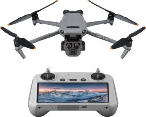 A gray quadcopter drone with a front-facing camera and a matching remote controller featuring a display screen showing a landscape.