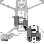 A drone with a dual speaker audio system attached to its underside is shown. An inset highlights the speaker details.