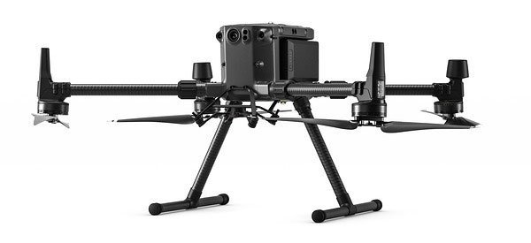 A black quadcopter drone with four propellers and landing gear against a white background.