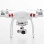 White drone with red stripes and a mounted camera, displayed against a plain white background.