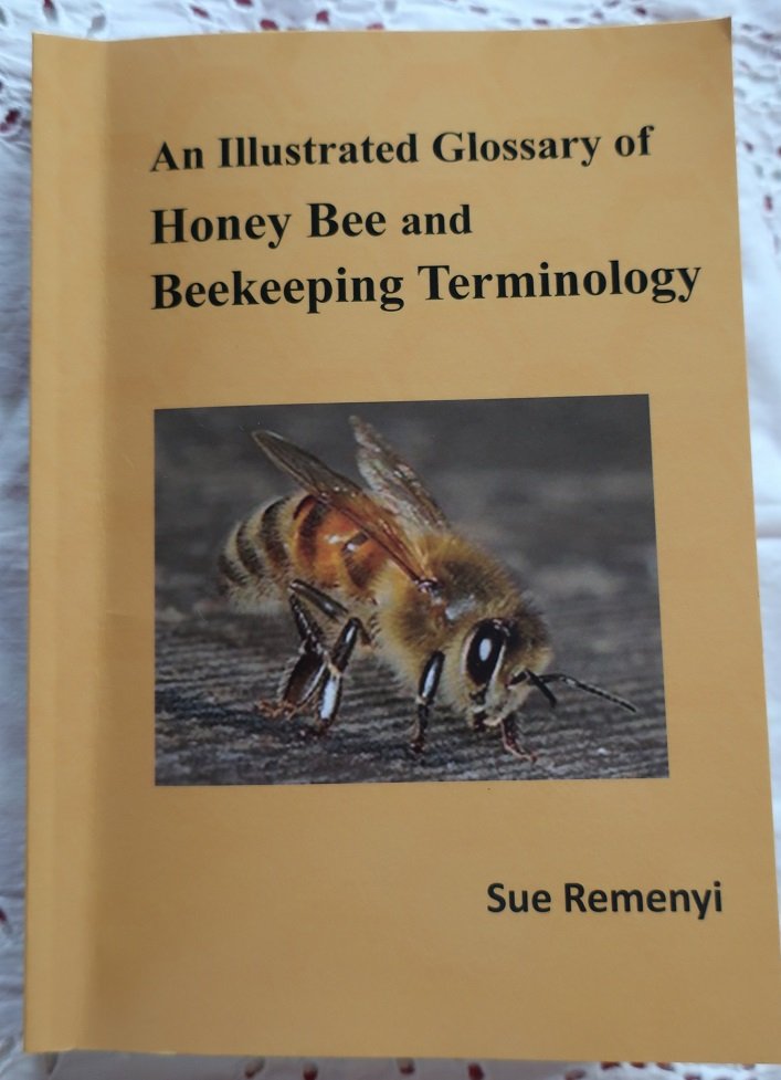 Cover of "An Illustrated Glossary of Honey Bee and Beekeeping Terminology" by Sue Remenyi, featuring a close-up image of a honey bee.