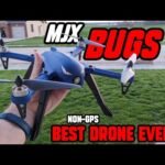 Person holding a blue MJX Bugs 3 drone with text overlay: "NON-GPS BEST DRONE EVER??" on a lawn backdrop.