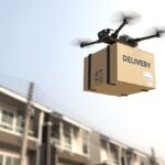 A delivery drone carries a package labeled "DELIVERY" above residential buildings against a clear sky.