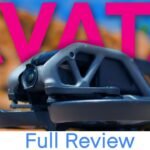 Close-up of a drone camera with the word "AVATA" in pink above and "Full Review" in blue letters below, set against a blurred natural background.