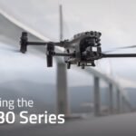 A DJI M30 drone flies in front of a bridge with mountains in the background. Text reads "Introducing the DJI M30 Series.