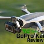 Close-up of a GoPro Karma drone in flight with a camera attached. The text reads "TechCrunch GoPro Karma Review" over the image.