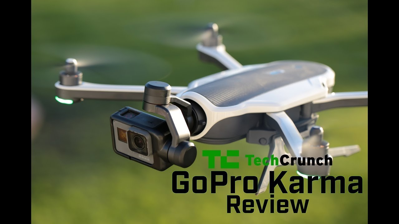 Close-up of a GoPro Karma drone in flight with a camera attached. The text reads "TechCrunch GoPro Karma Review" over the image.