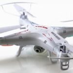 A white quadcopter drone with protective guards around its propellers on a white background.